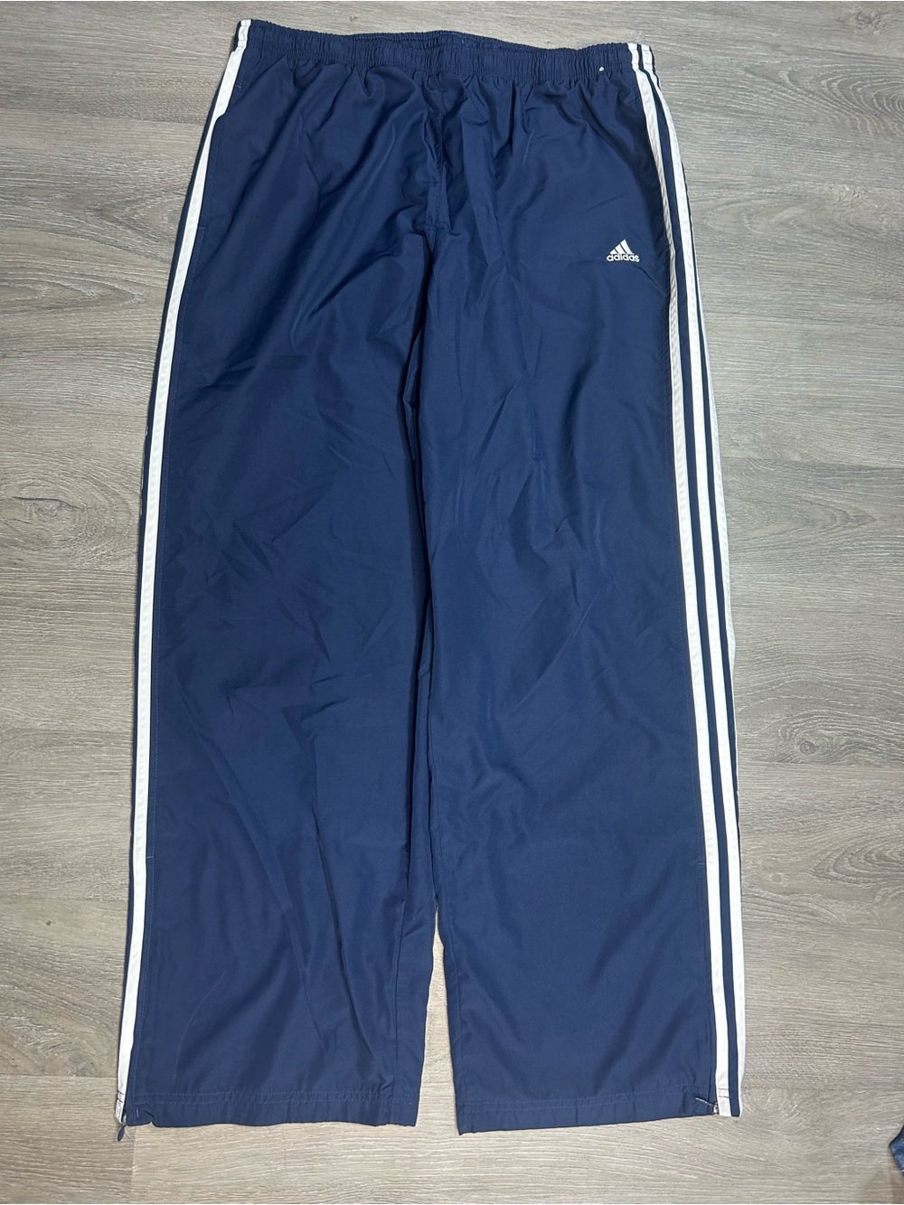 Adidas woman’s navy blue track pants with white stripes, size XL